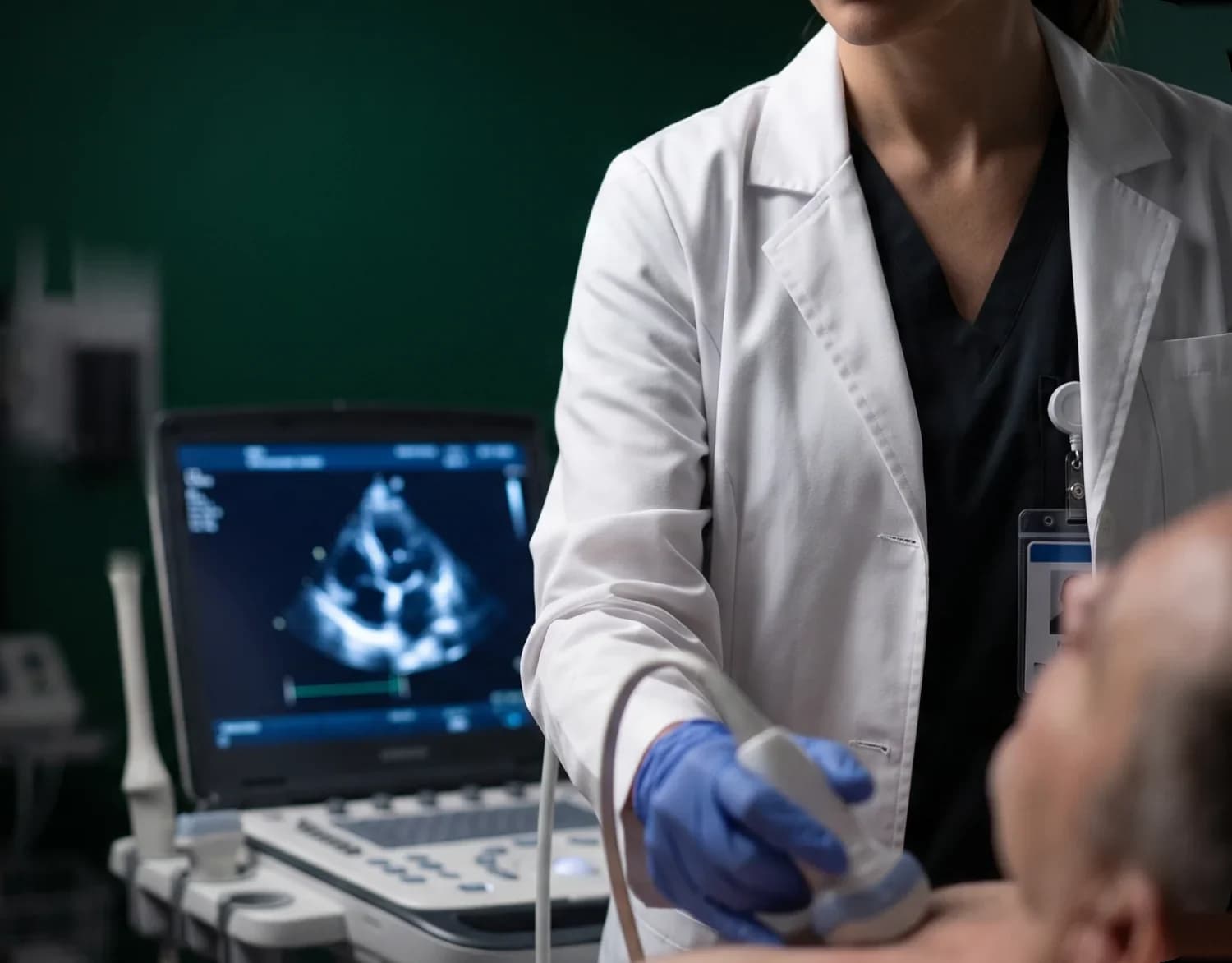 Doctor performing an ultrasound scan on a patient